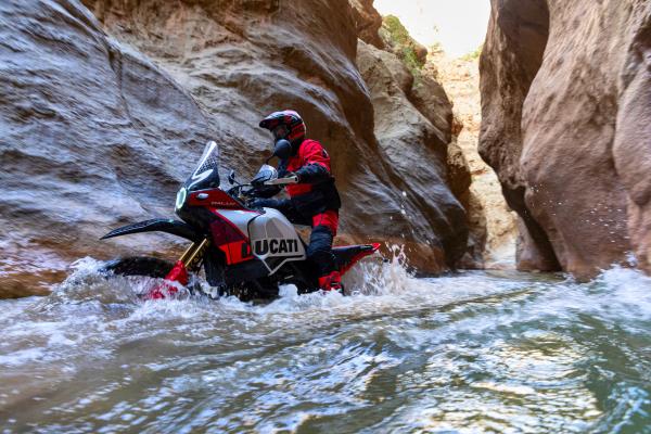  motorcycle riding along a flooded canyon